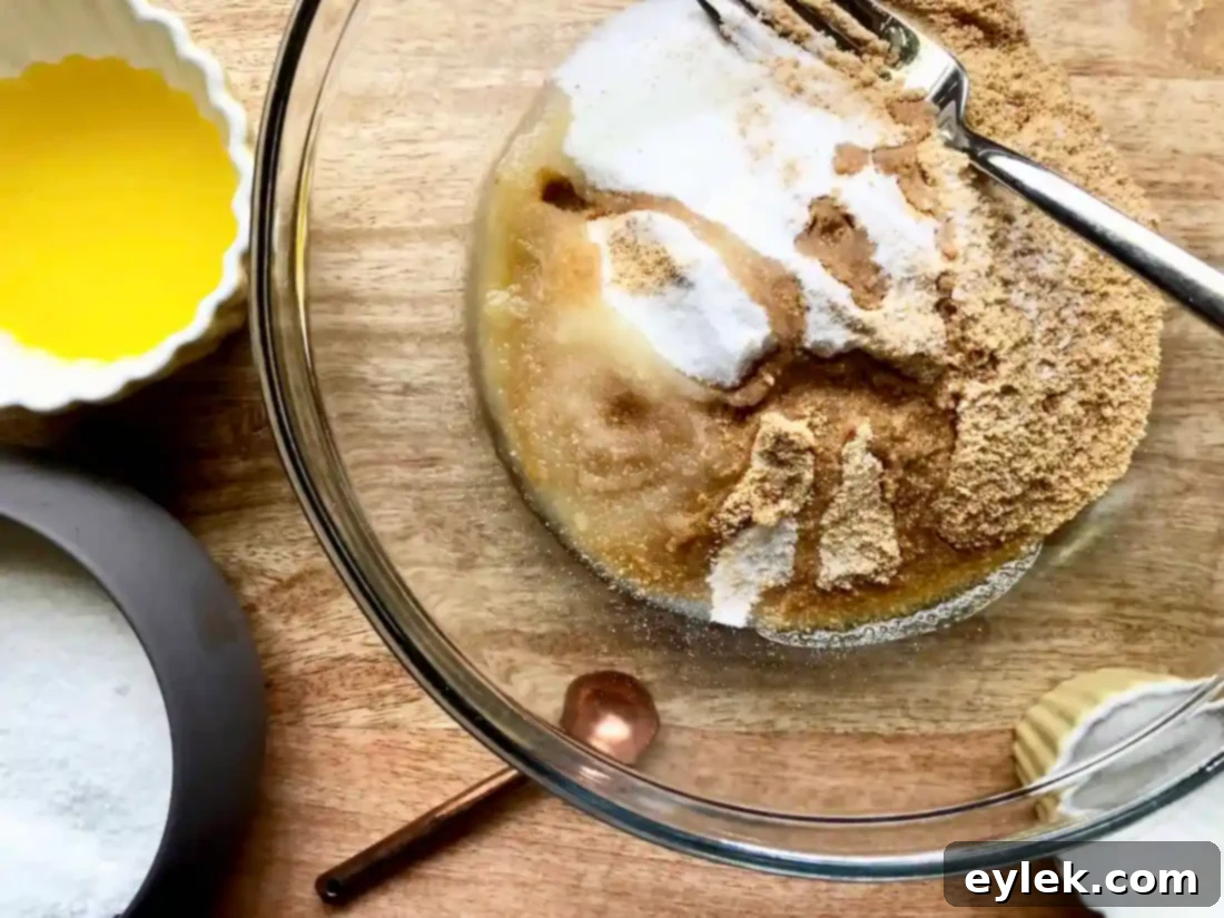 Mixing graham cracker crumbs with butter
