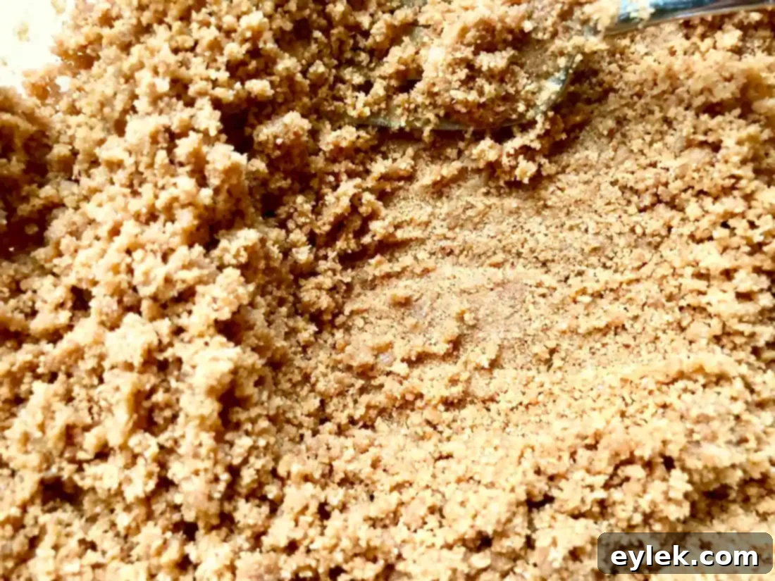 Melted butter being added to graham cracker crumbs