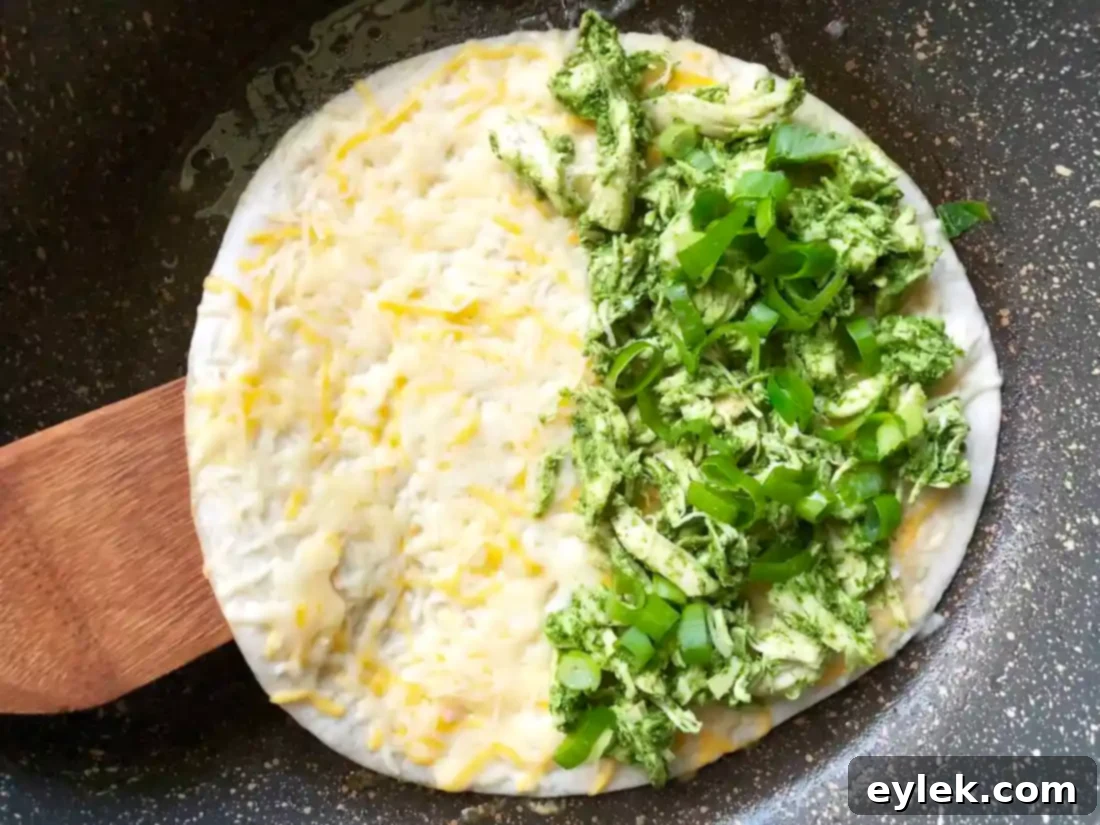 Cooked chicken fajita quesadilla being cut into wedges.