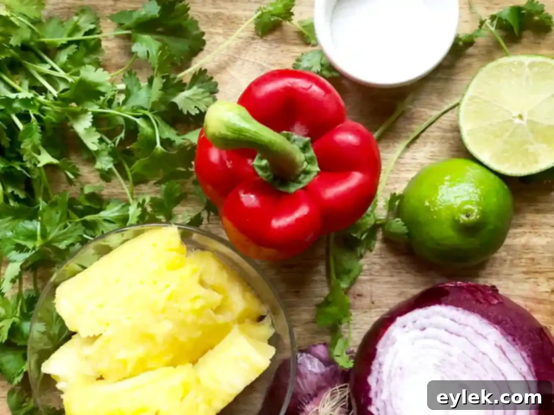 Ingredients for pineapple salsa: diced pineapple, red onion, red bell pepper, cilantro.