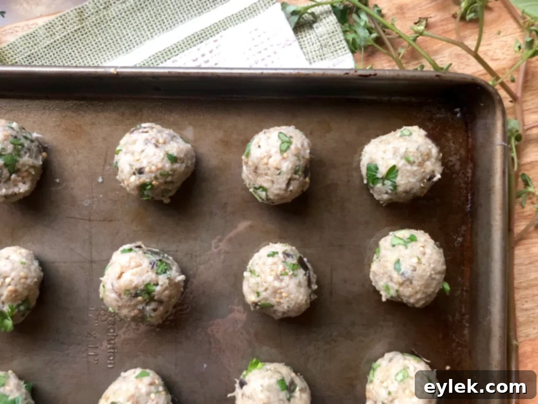 eggplant parmesan meatballs on a baking sheet