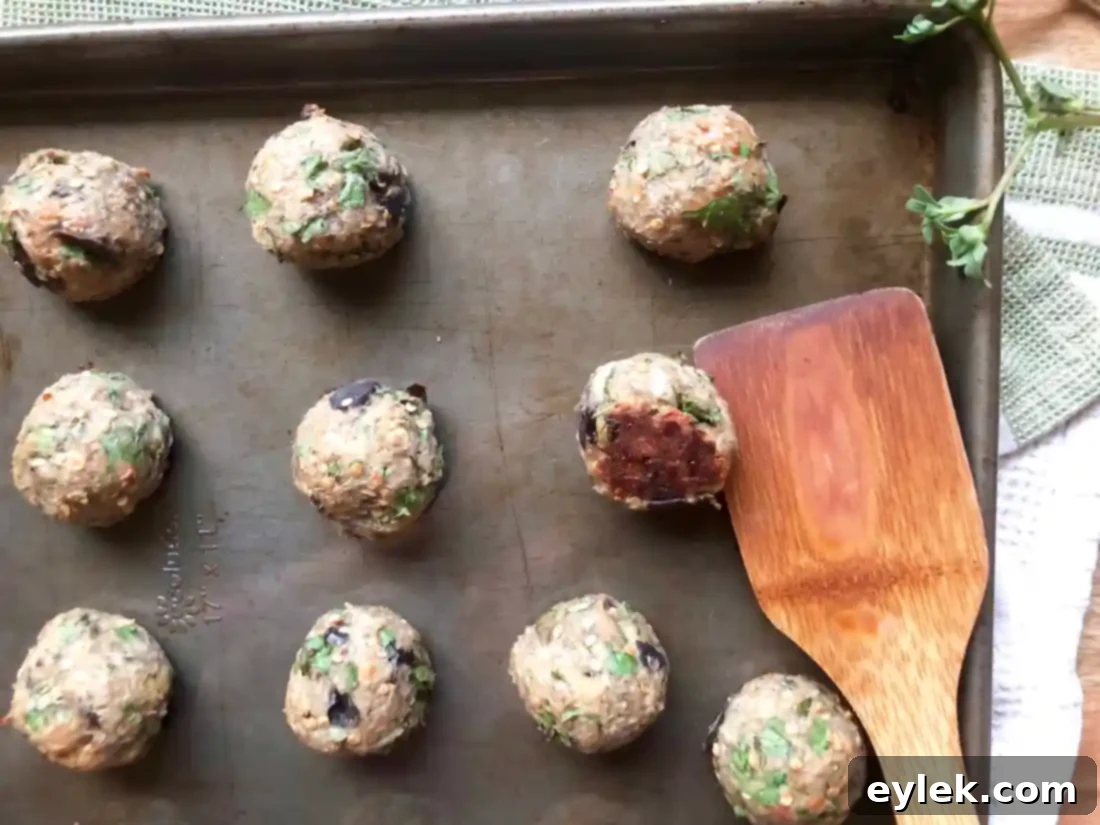 eggplant parmesan meatballs simmering in marinara sauce