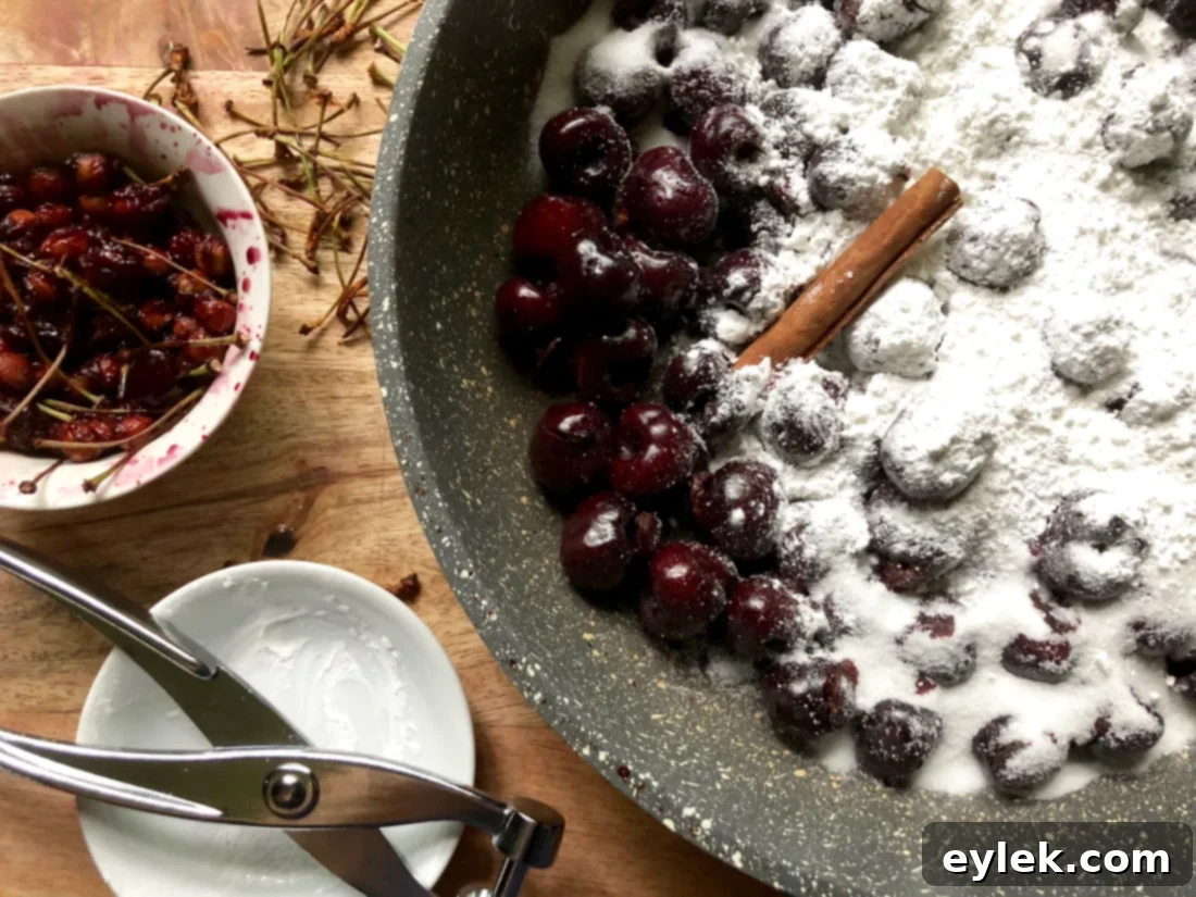 Fresh cherries being pitted with a cherry pitter