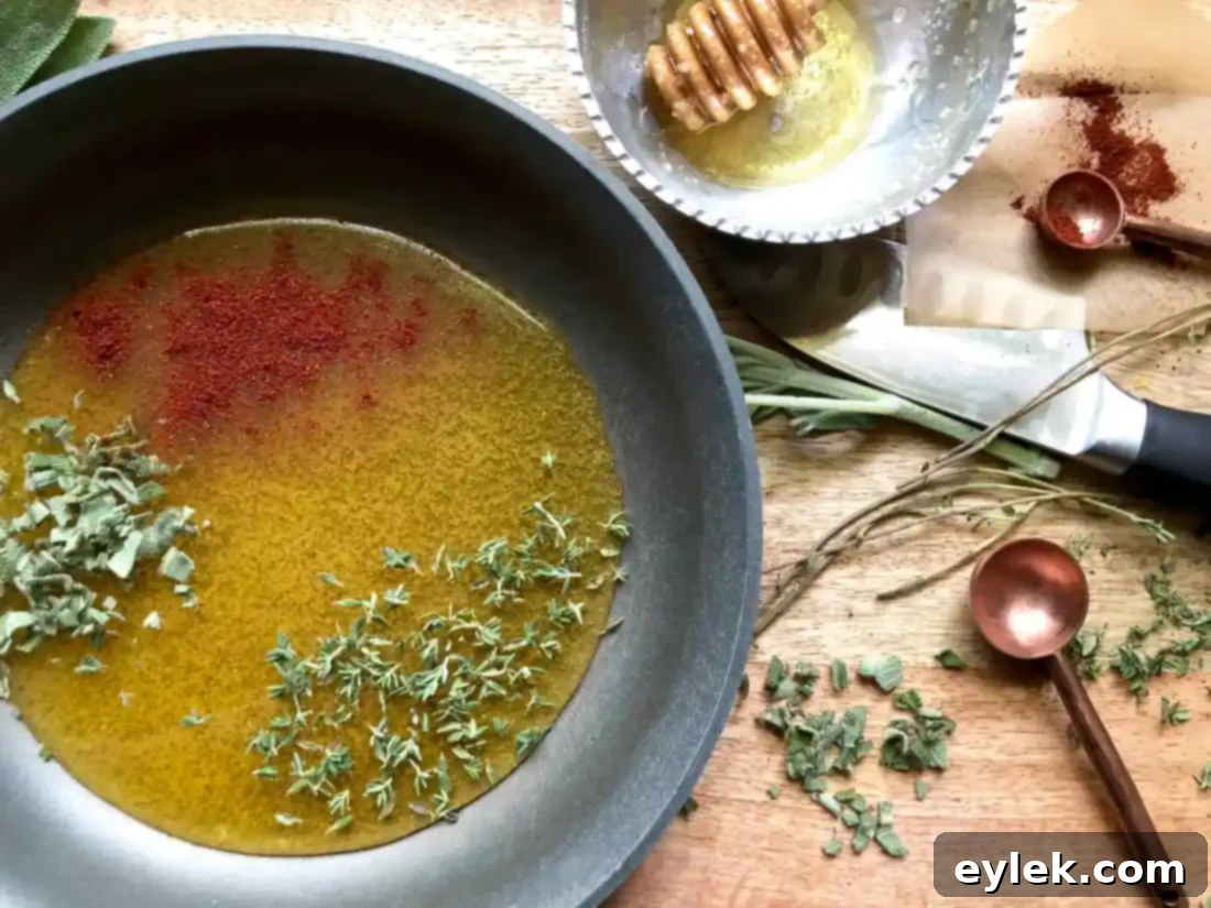 Honey glaze mixture simmering in a small saucepan