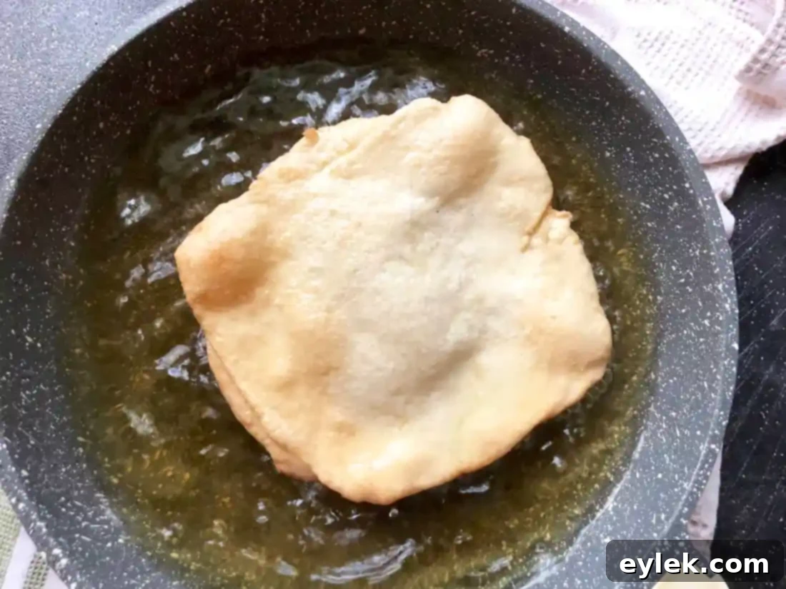 Jamie Oliver's fried & grilled pizza dough frying in oil