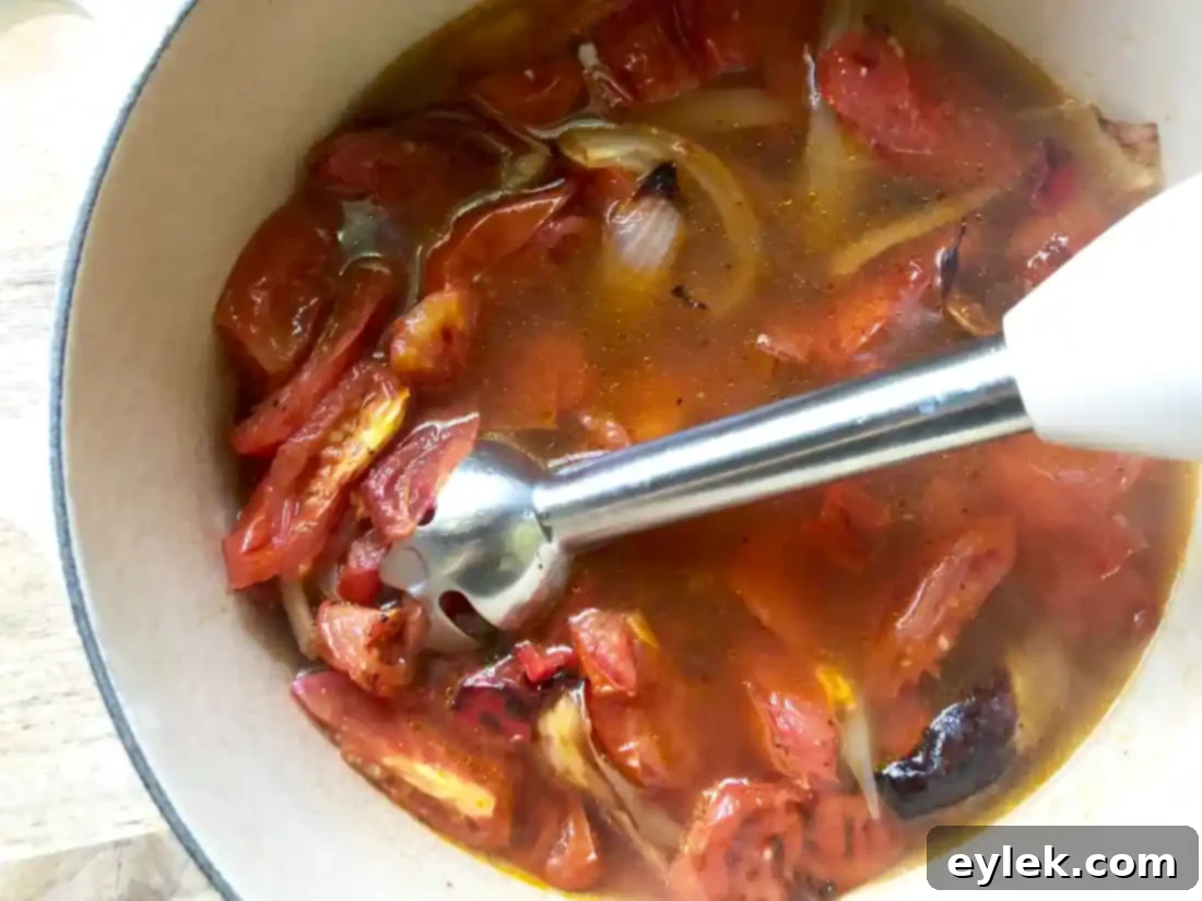 Close-up of smooth tomato soup in a Dutch oven.