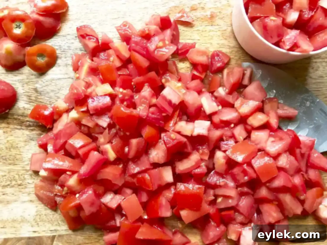 blending tomatoes and broth for cheesy garden minestrone