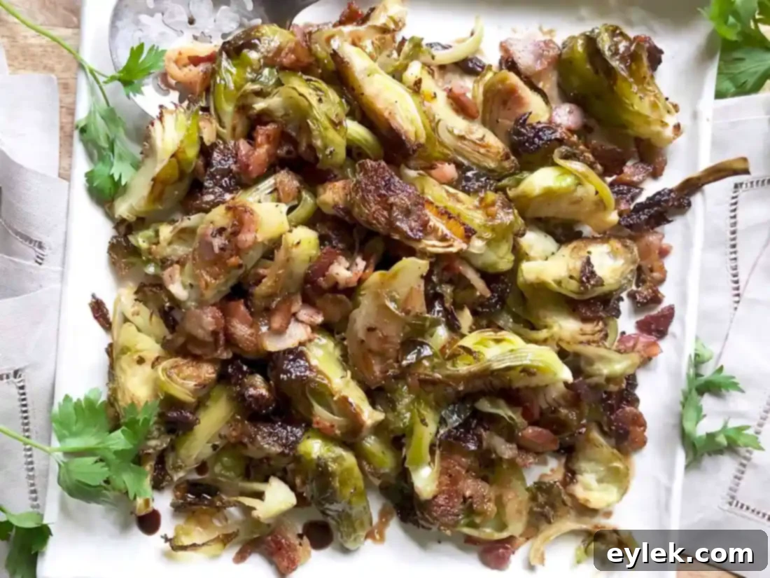 close up of balsamic roasted brussels sprouts with bacon in a white bowl