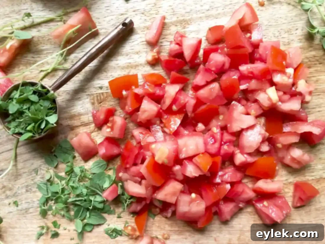 Adding tomatoes and herbs to the soup base