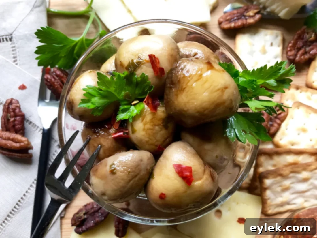 An even wider shot of a lavish cheese and appetizer board, prominently featuring marinated mushrooms.
