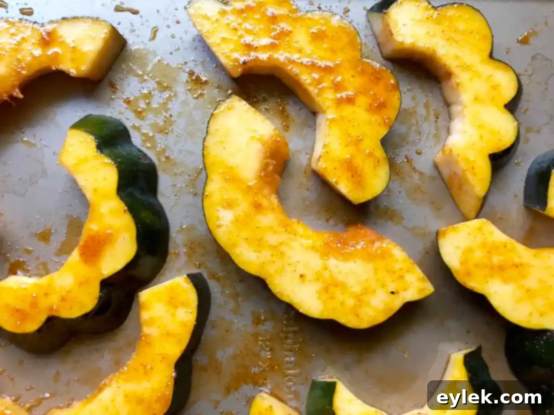 acorn squash slices arranged on baking sheet