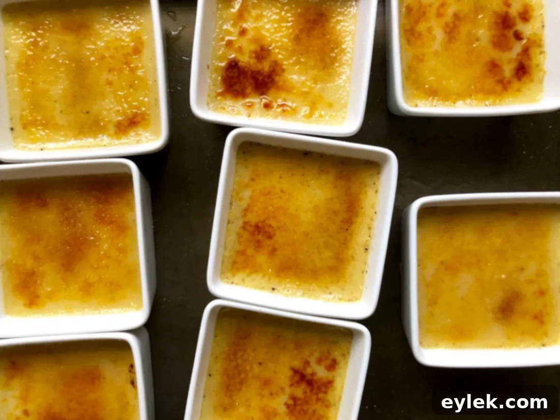 Spoon breaking the caramelized sugar on pumpkin crème brûlée