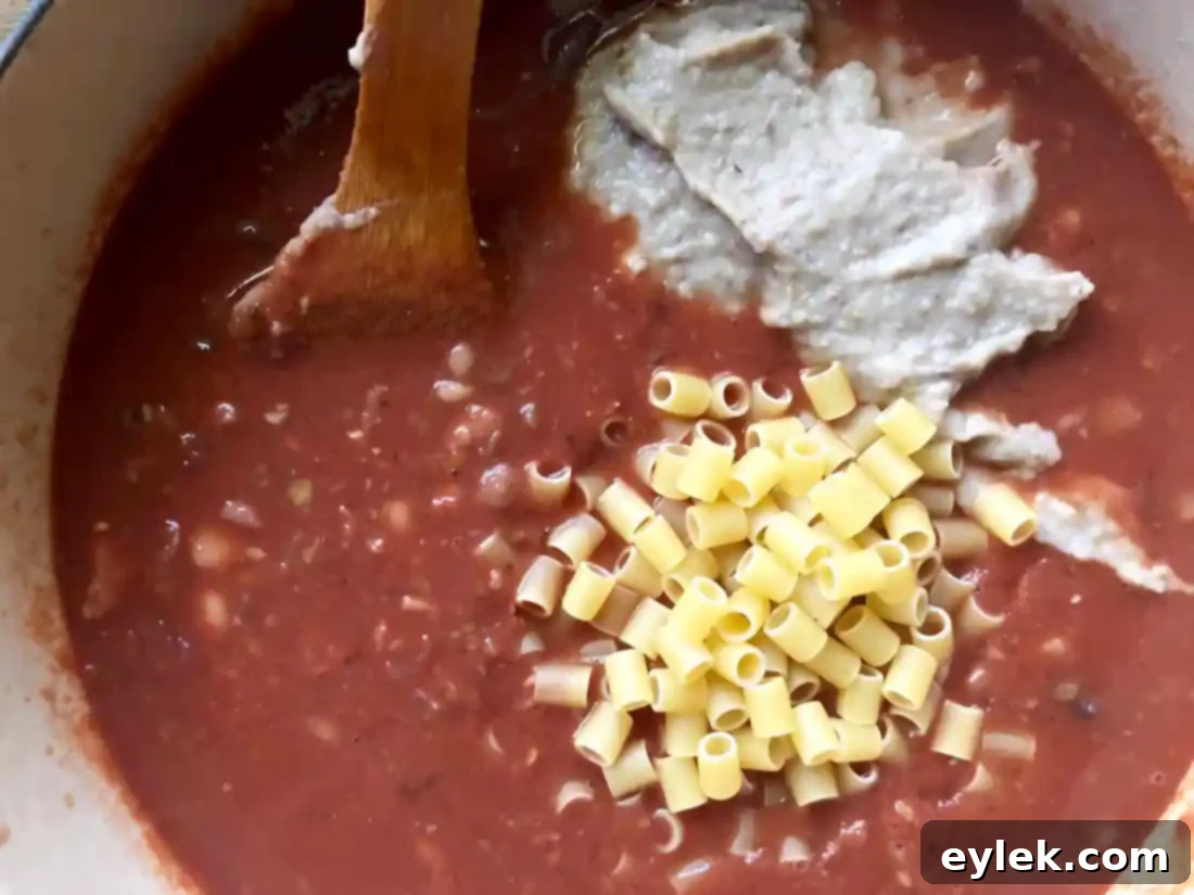 Ina Garten's Pasta e Fagioli simmering, with pasta becoming tender