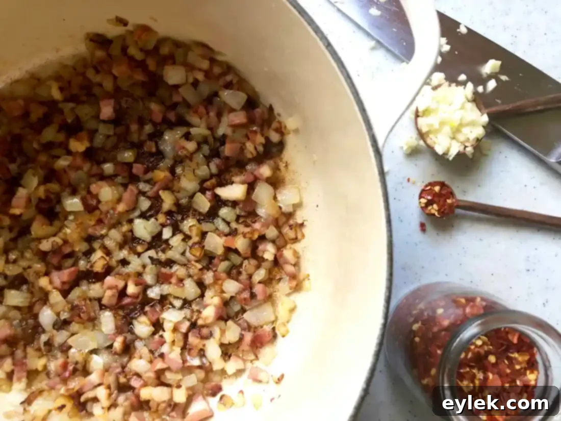 Bean puree being added to the soup to thicken Ina Garten's Pasta e Fagioli