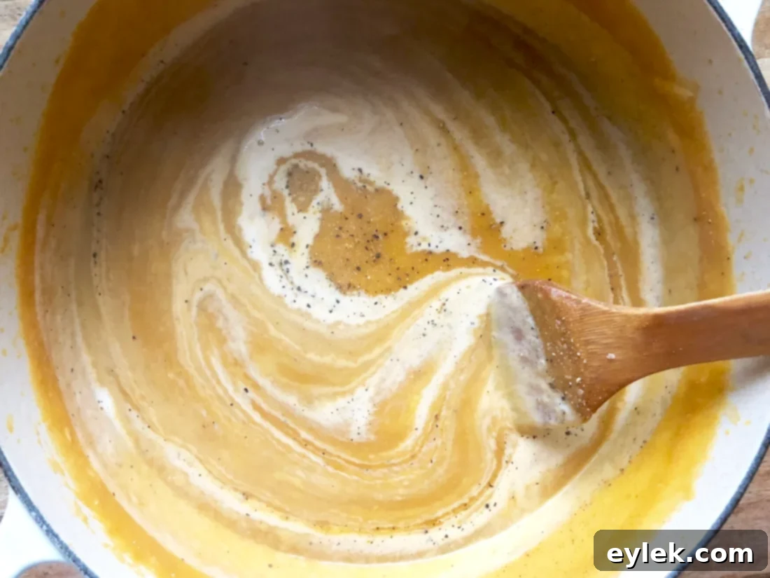 A bowl of creamy pumpkin soup, ready for garnishing