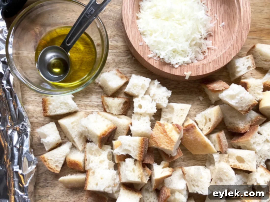 Bread cubes tossed with olive oil, ready for Manchego cheese and baking