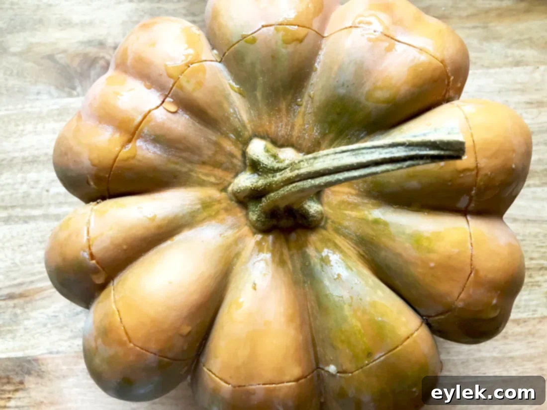 A whole roasted pumpkin, hollowed out and ready to be filled with soup