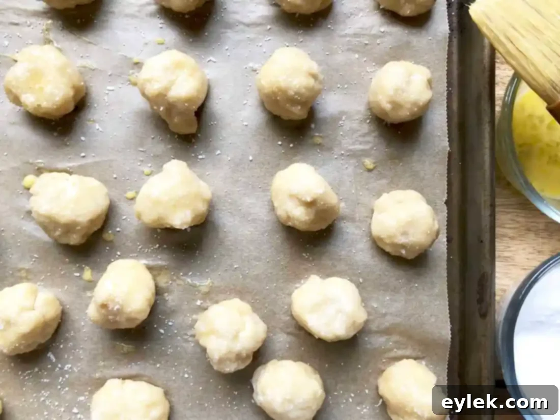 Boiled pretzel dough balls draining on paper towels