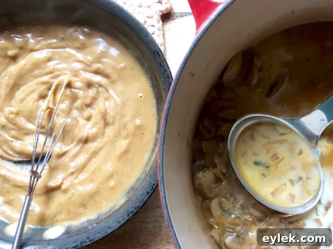 Milk being poured into the simmering soup, to create a creamy base.