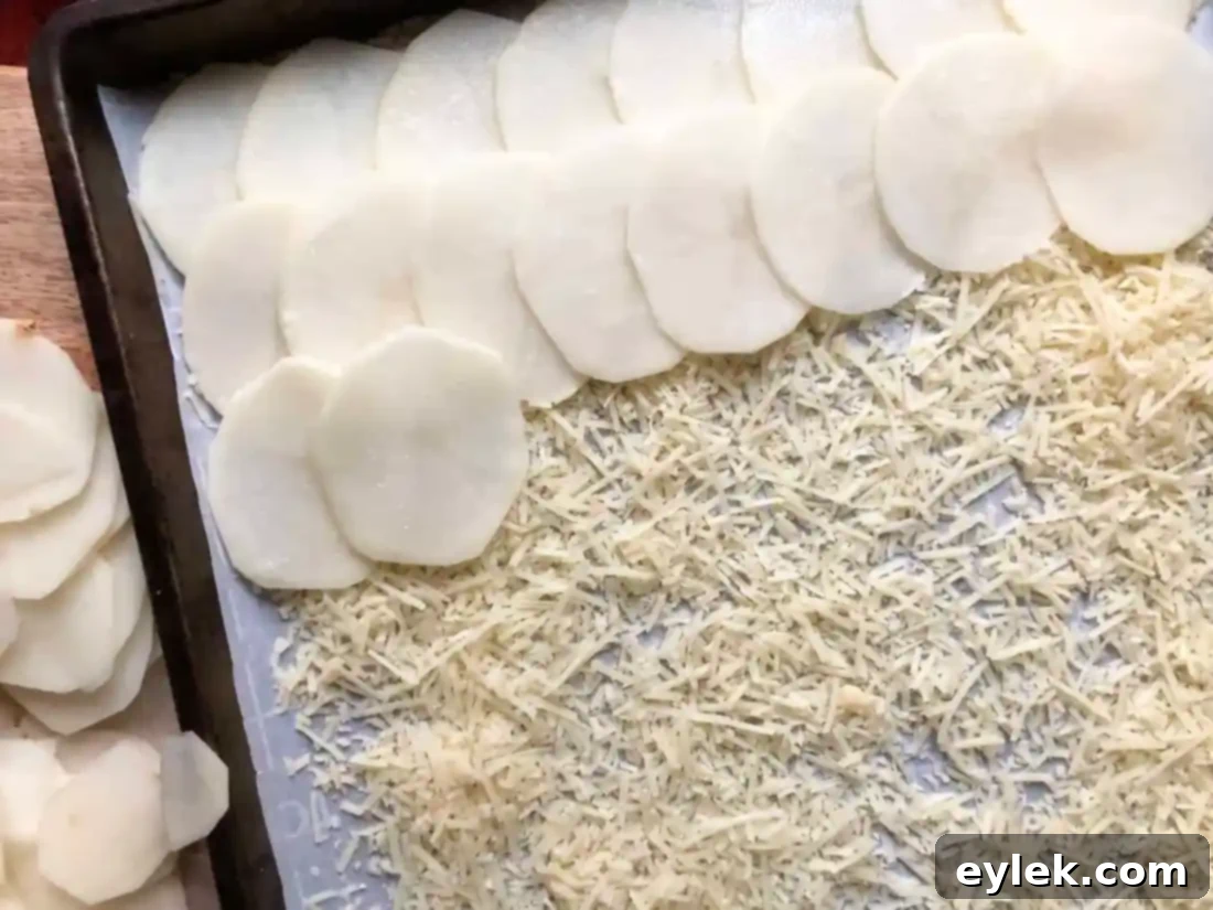 Beef-Filled Scalloped Potato Roulade 11 Potato slices topped with Parmesan, ready for oven