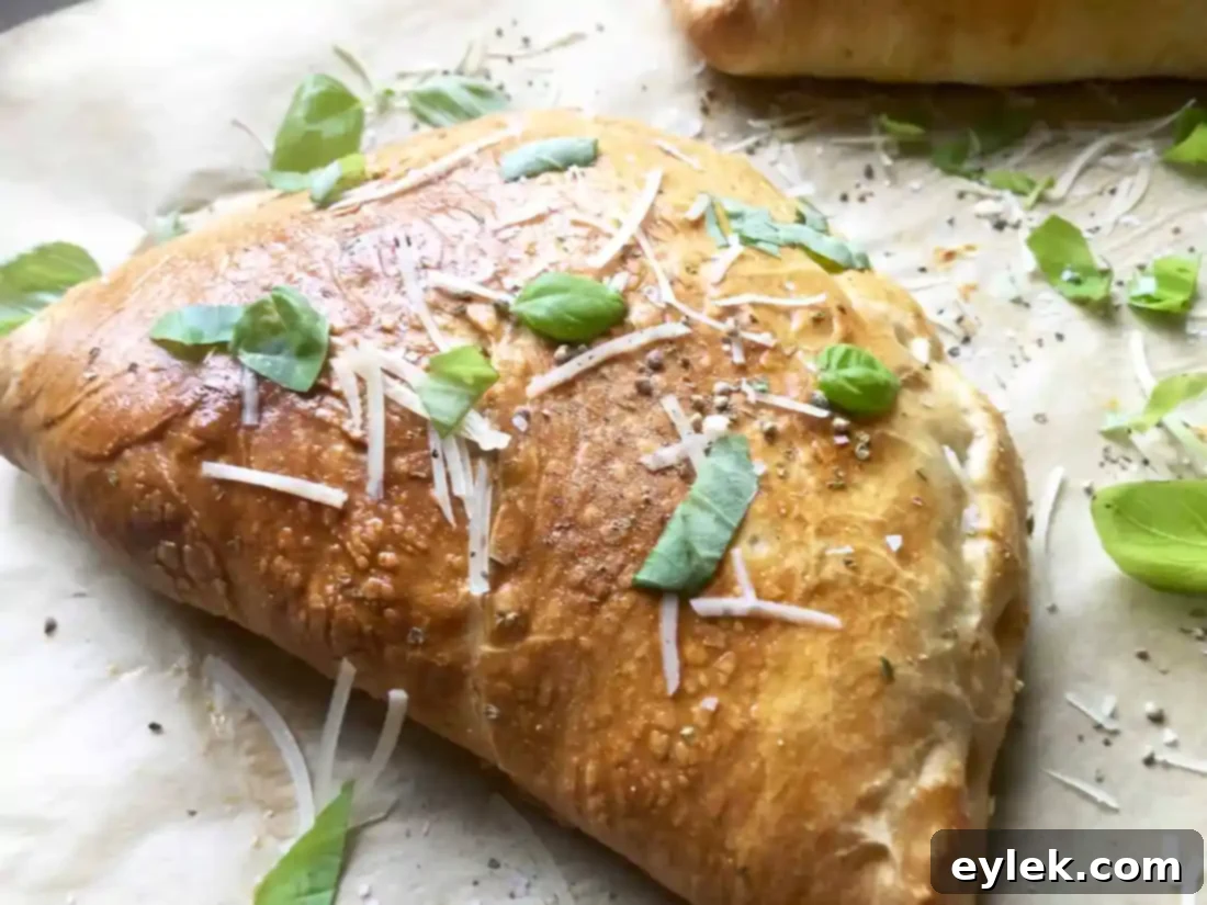 Close-up of a sliced chicken and mushroom calzone, showing the filling