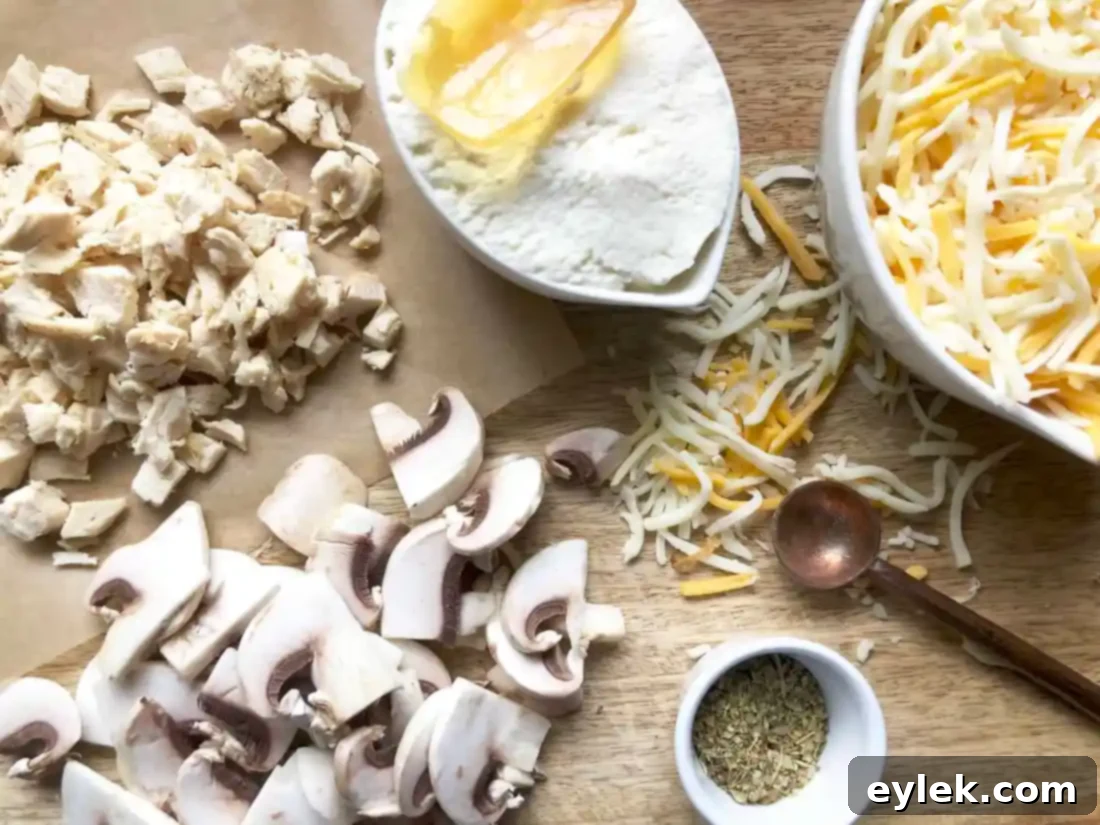 Mixed calzone filling with shredded cheese, ricotta, chicken, and mushrooms in a bowl