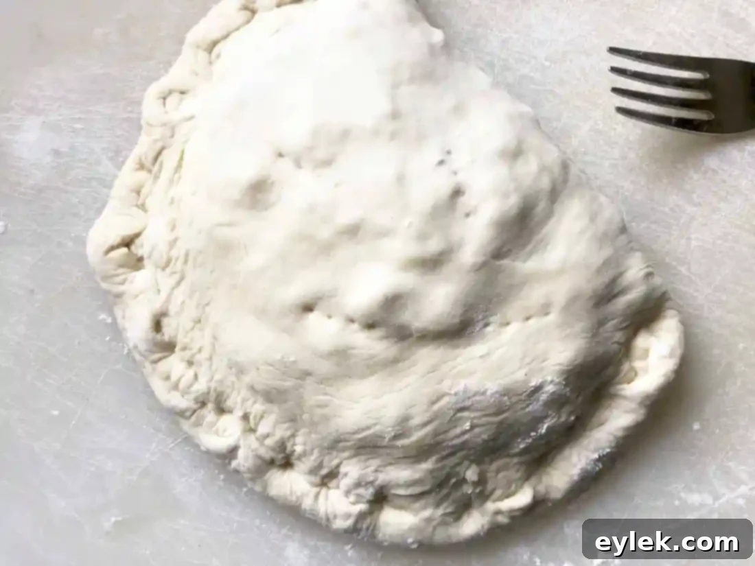 Calzone edge being crimped and sealed
