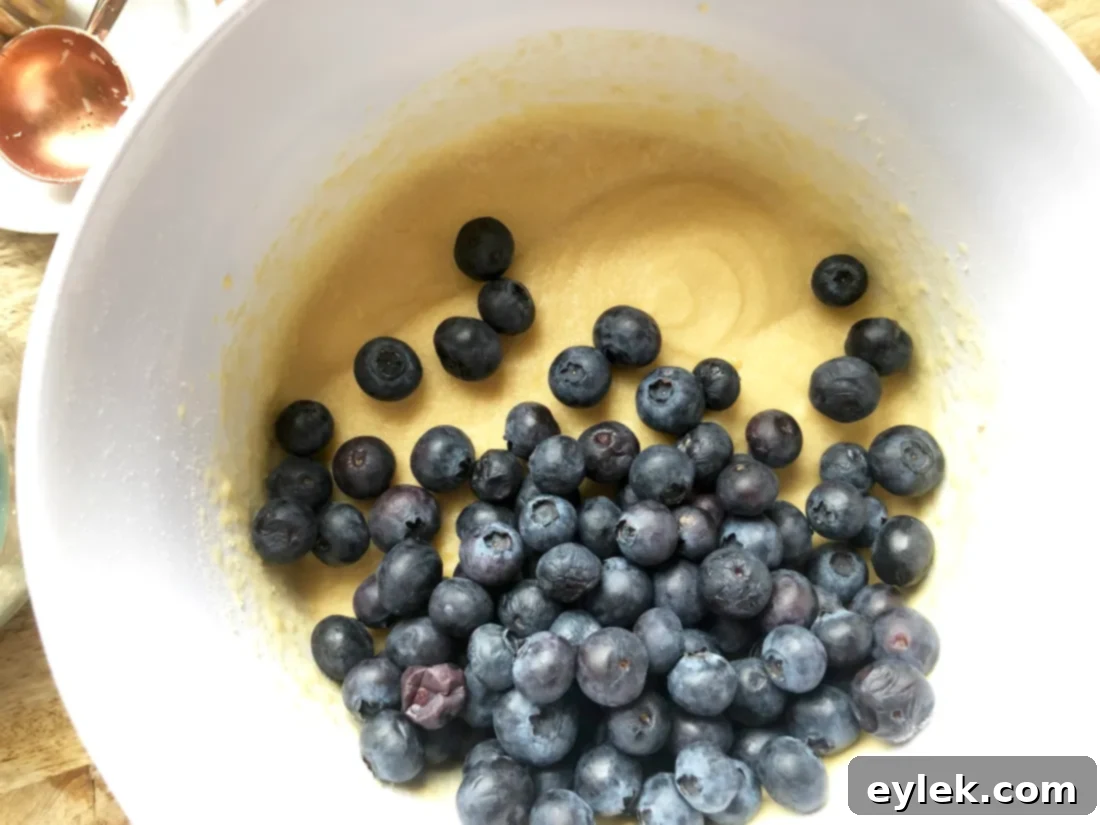 Thick coconut flour muffin batter with blueberries on top