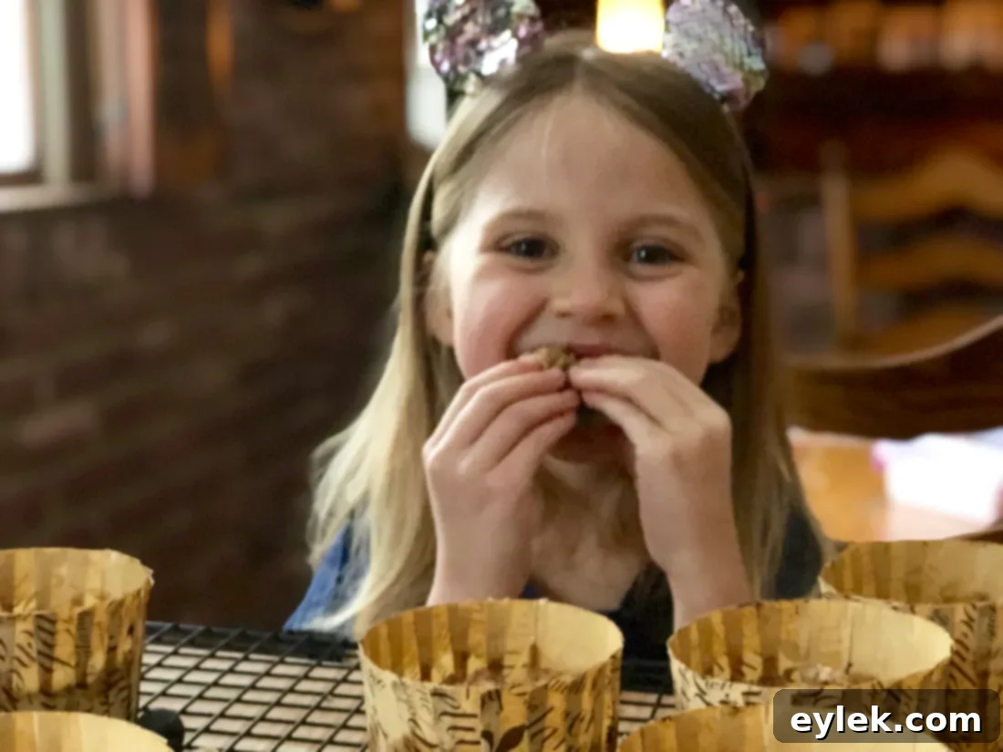 Happy child enjoying a gluten-free blueberry muffin