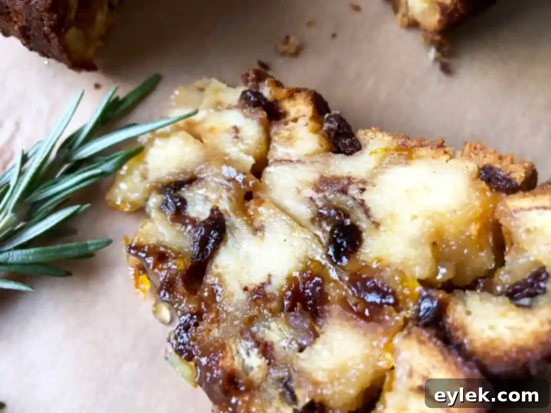 Slice of cinnamon raisin bread pudding with whipped cream and fruit