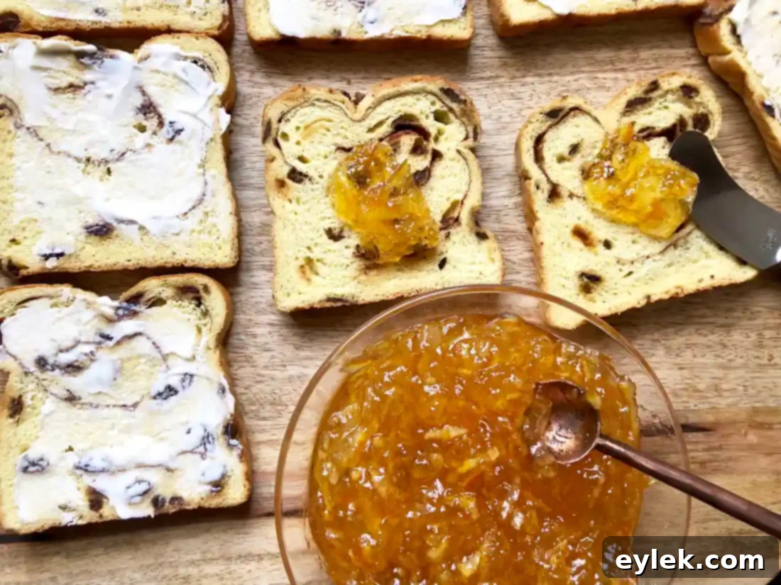 Preparing cinnamon raisin bread slices with butter and marmalade