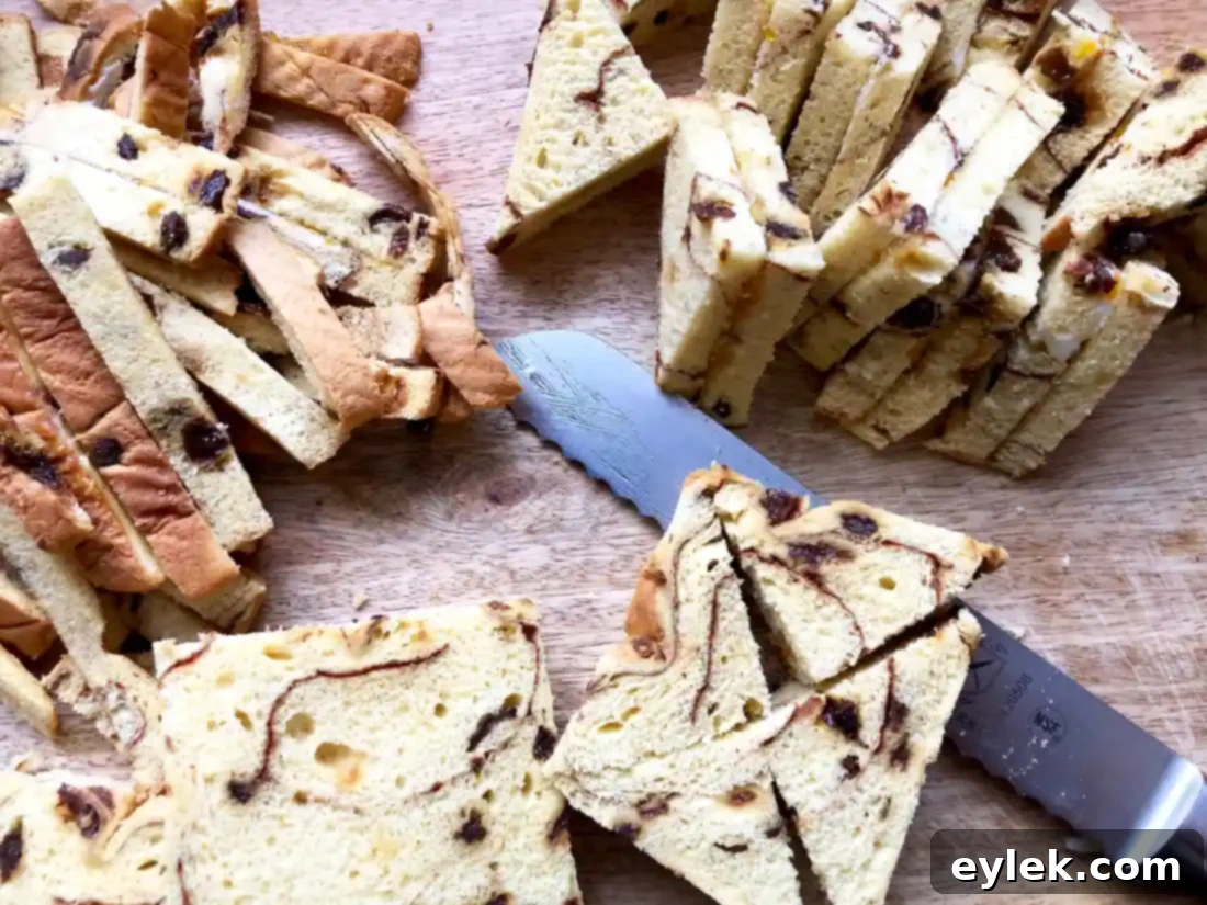 Diagonally cut cinnamon raisin bread sandwiches arranged in a baking pan