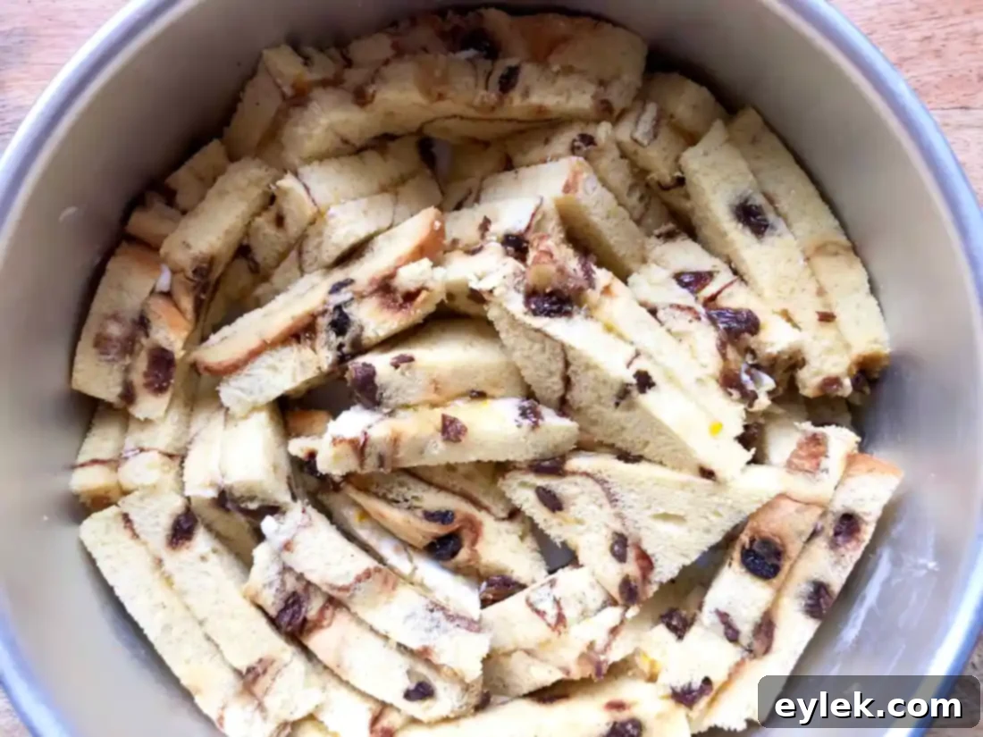 Sprinkling raisin, brown sugar, and cinnamon mixture over bread pudding base