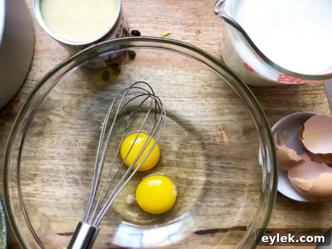 Pouring custard mixture over bread in baking pans