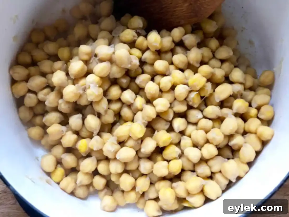 Chickpeas simmering, foam and skins removed