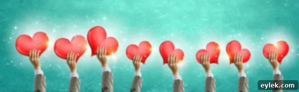 Group of people holding heart cards, symbolizing love and kindness