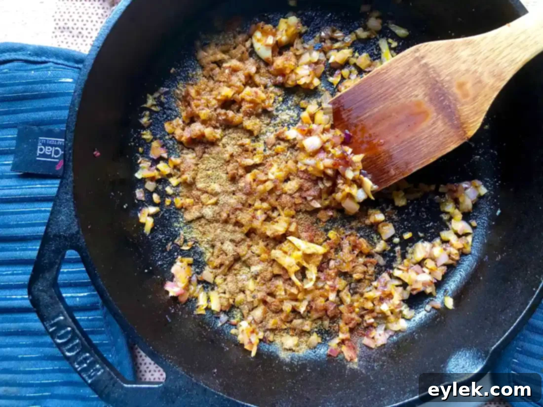Tomatoes added to the spiced onion mixture