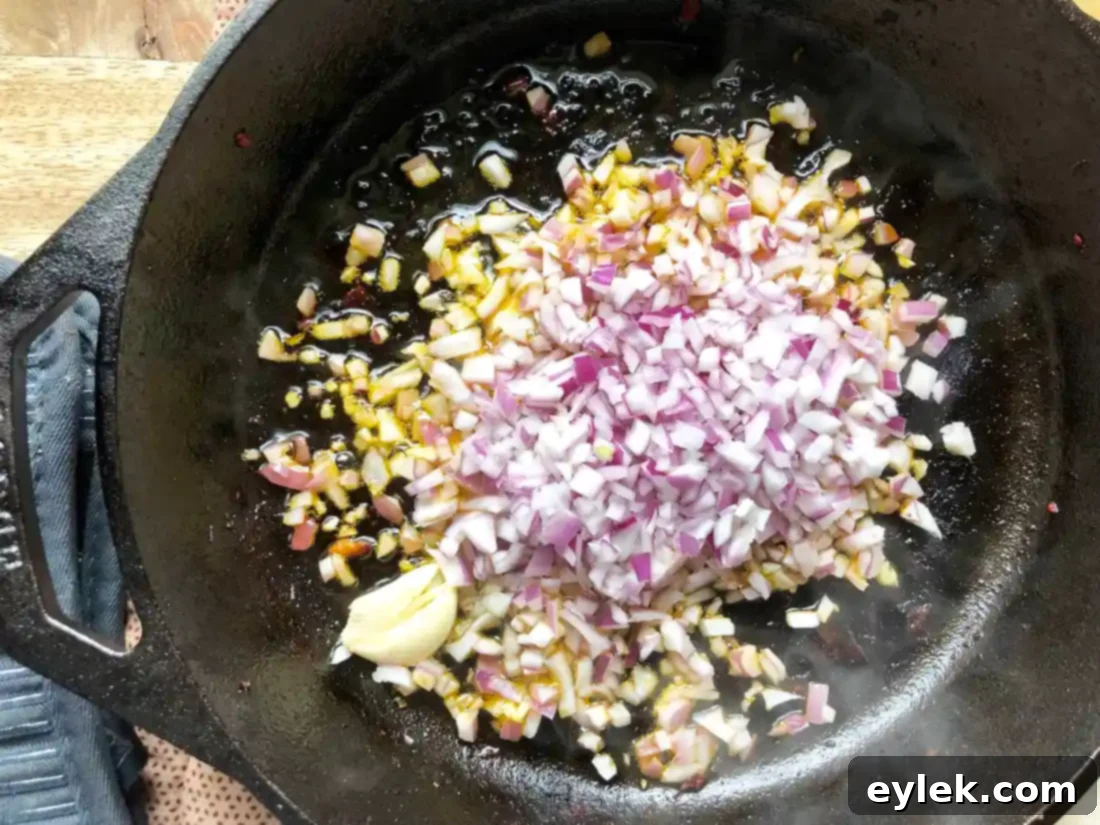 Saffron and wine mixture added to skillet