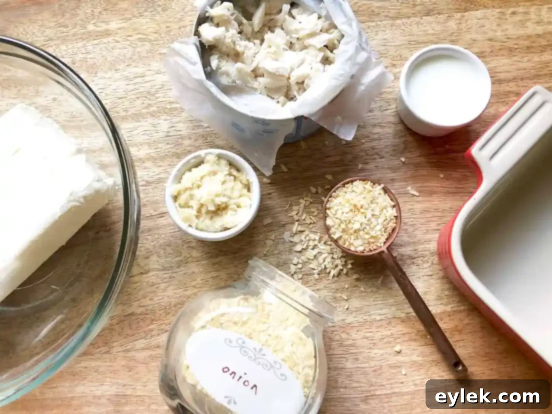 Warm and creamy crab dip in a small white baking dish, ready to be served