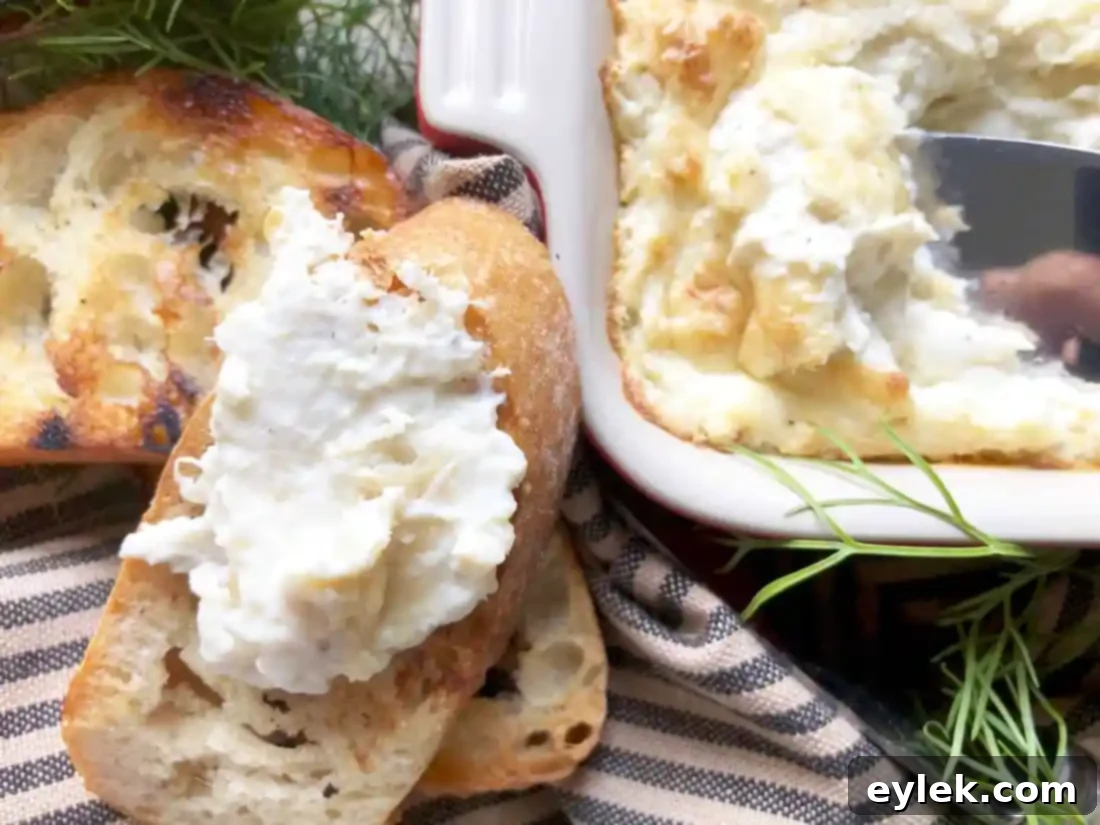 Warm and creamy crab dip served with toasted baguette slices and fresh cucumber