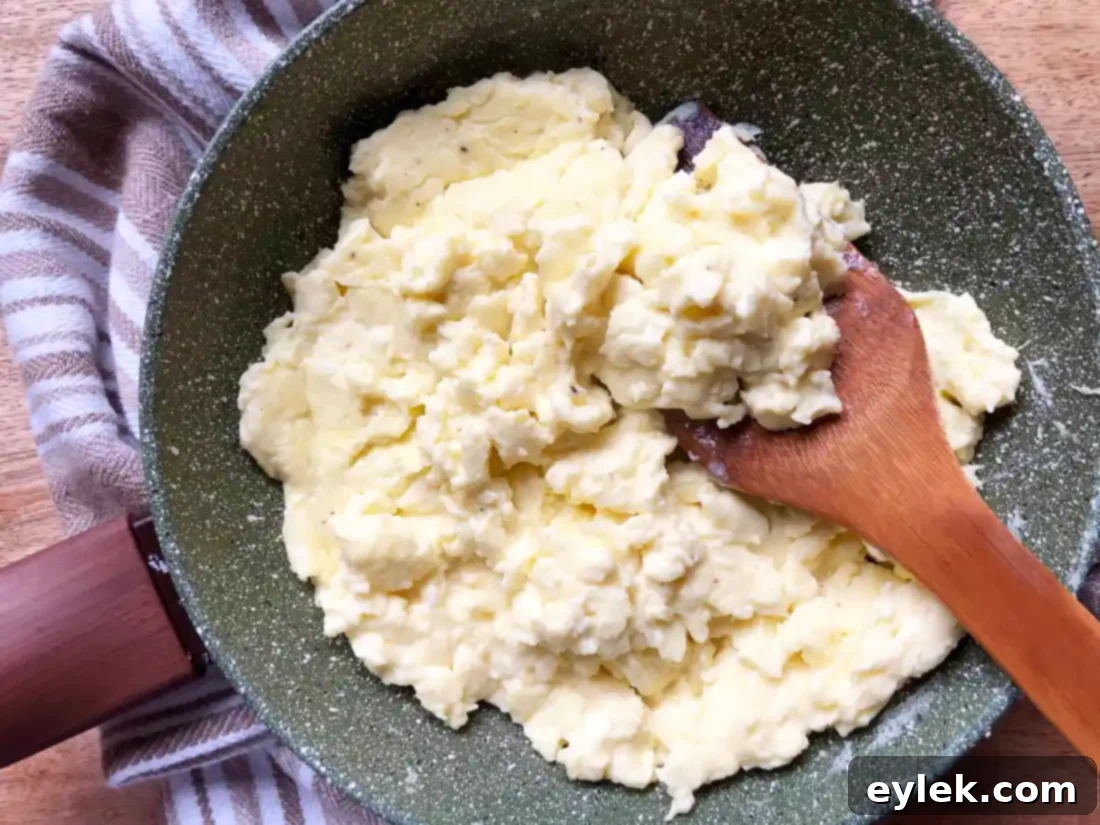 Cooking the fluffy cream cheese scrambled eggs