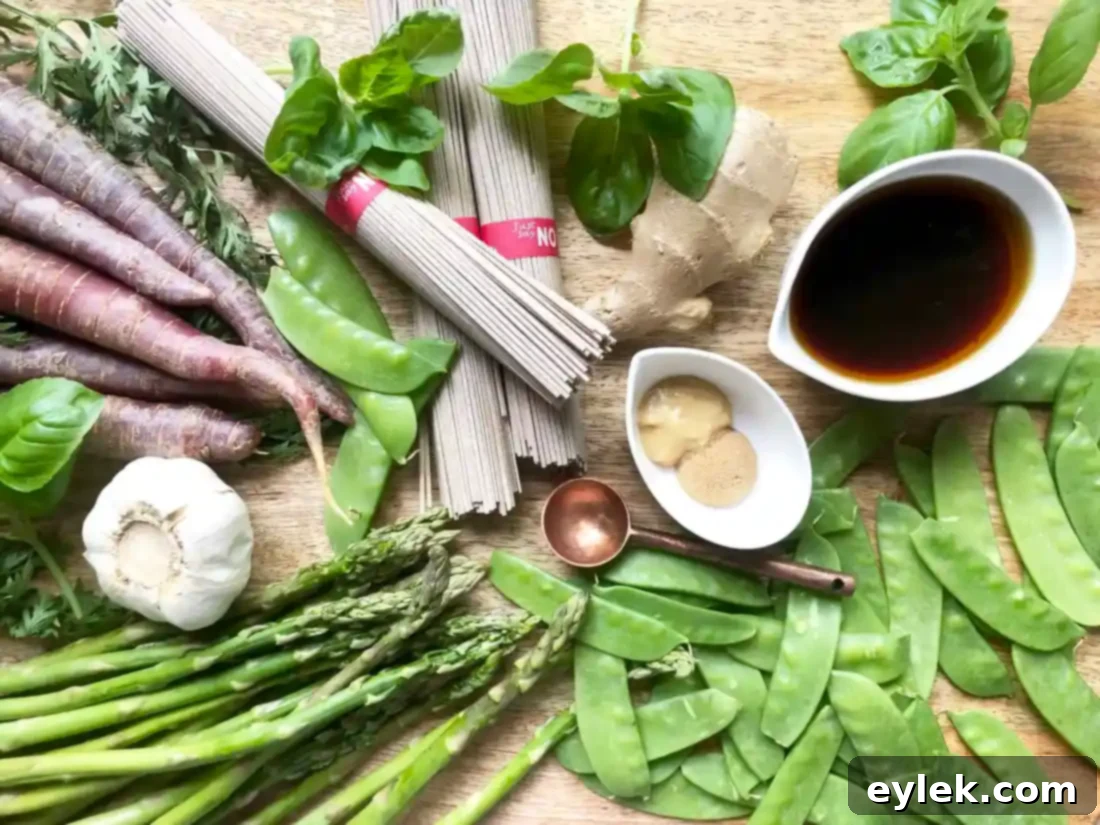 Soba Noodle Salad with Snow Peas, Asparagus, and Carrot Ribbons, garnished with fresh basil