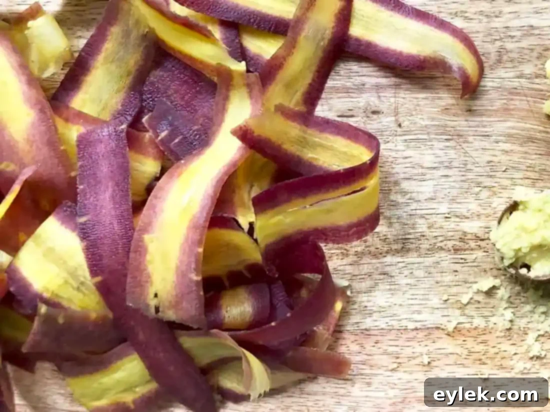 Close-up of freshly peeled purple carrot ribbons in a bowl, ready for the Soba Noodle Salad