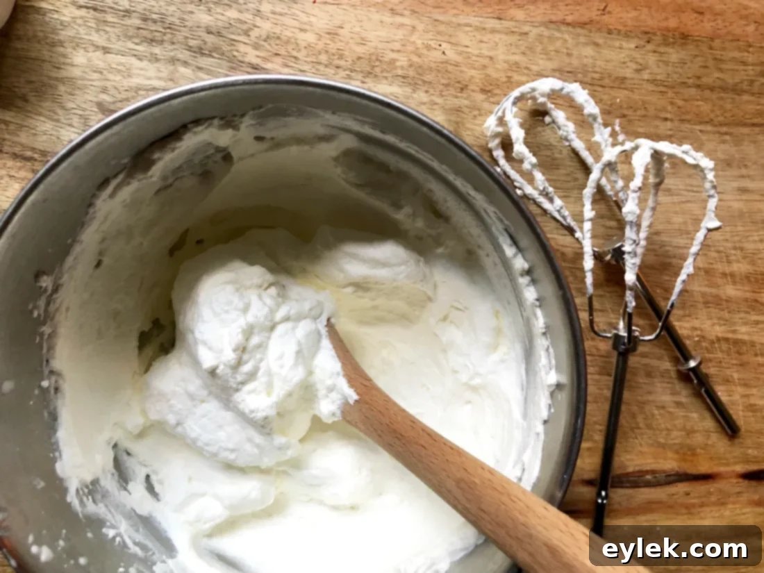 Whisking heavy cream in a cold bowl for topping