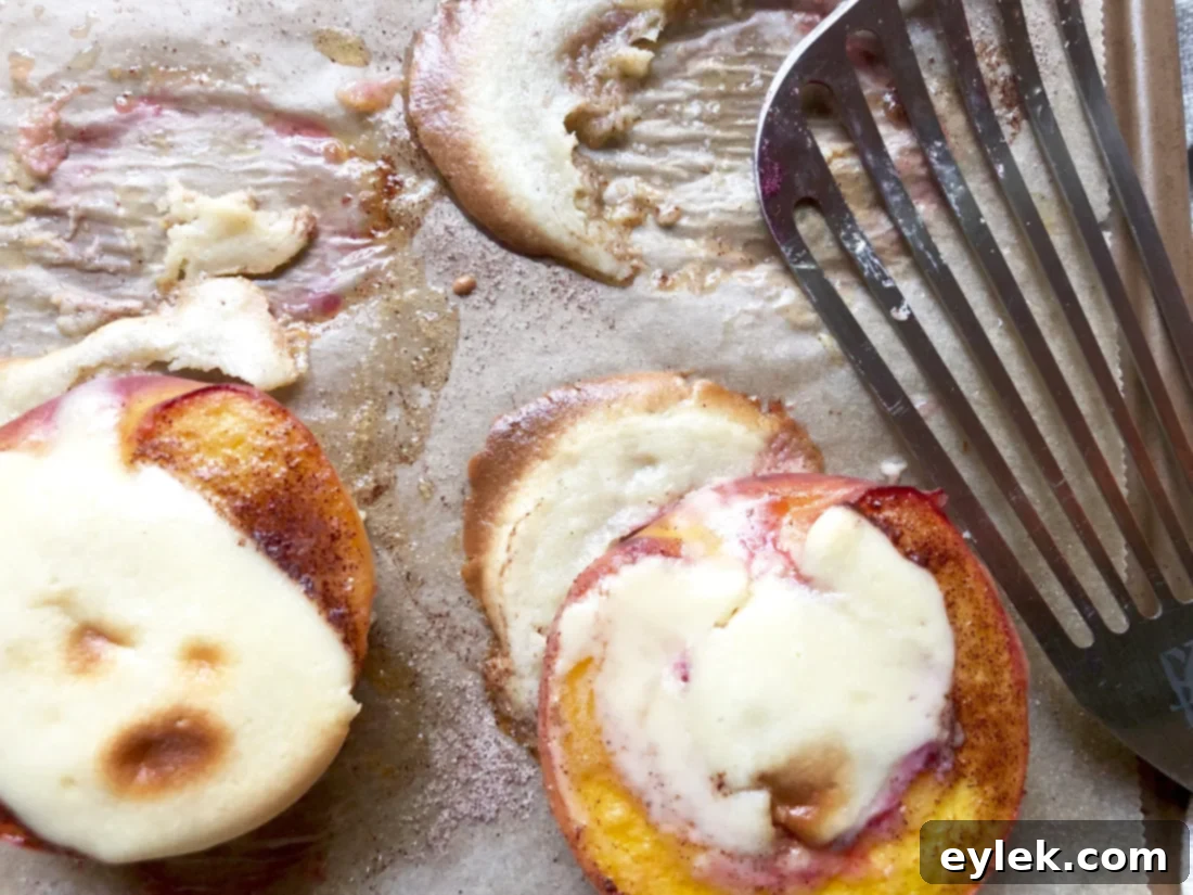 A serving of cheesecake-stuffed peach halves, ready to eat
