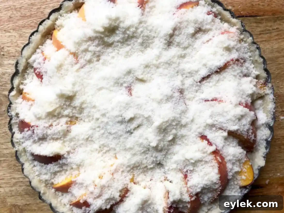 Unbaked peach tart with generous crumb topping