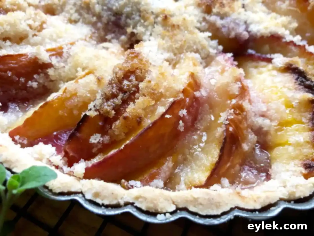 Slice of peach tart with a golden crust and juicy filling