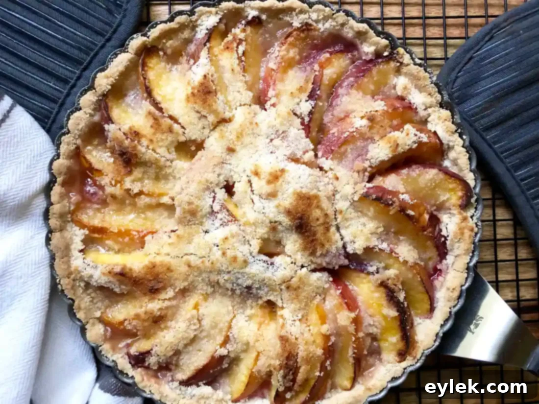 Delicious peach tart served with a scoop of vanilla ice cream