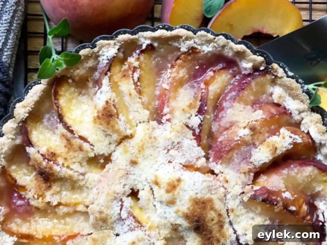 Homemade peach tart with a scoop of whipped cream