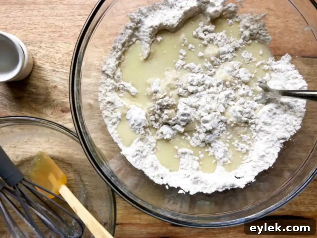 Dough being pressed into a tart pan for a homemade peach tart